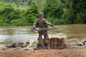 Colombian soldier armed by river